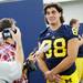 Michigan senior defensive end Craig Roh shows off his long locks as he speaks with a reporter during media day at the Al Glick Field House on Sunday afternoon. Melanie Maxwell I AnnArbor.com